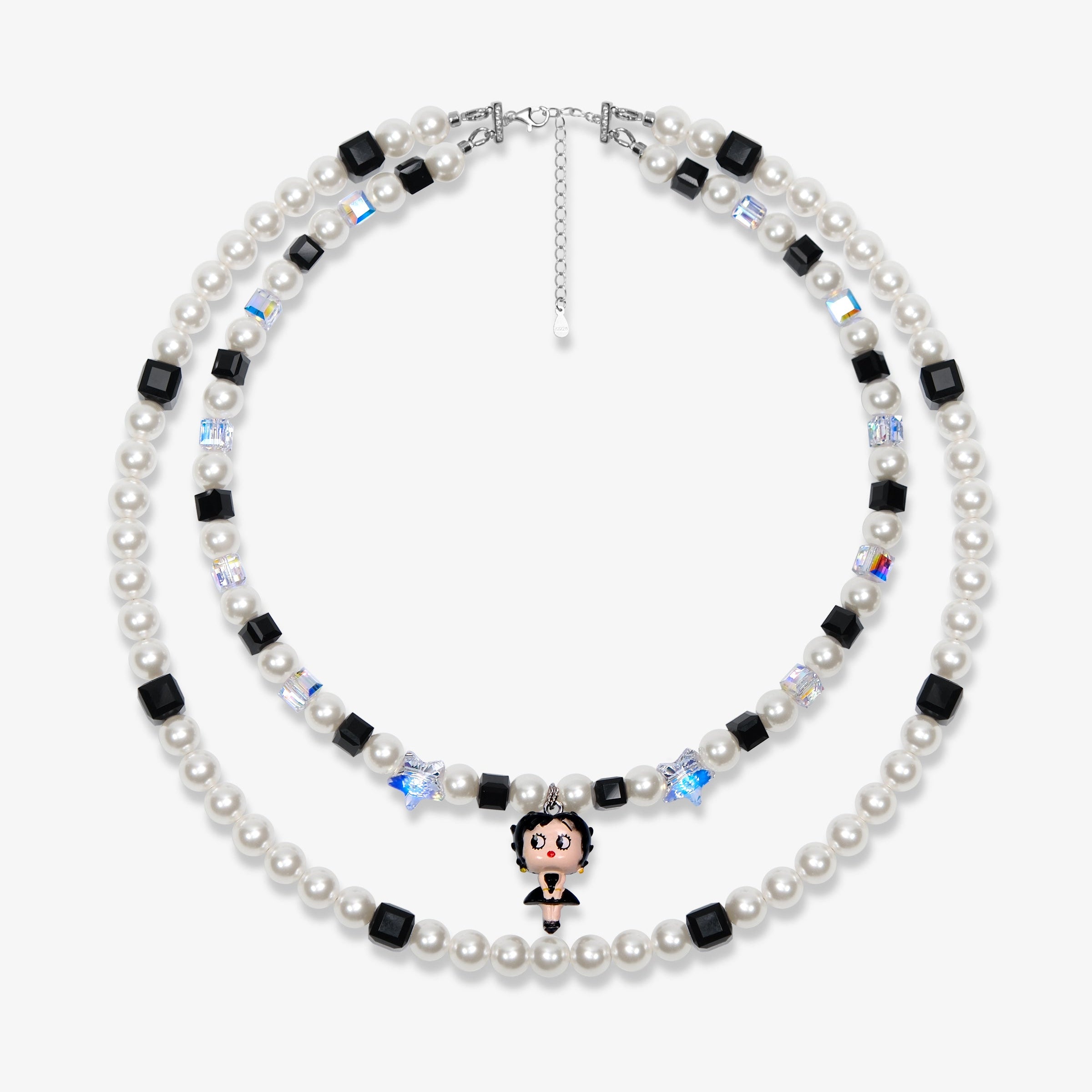 Two-strand white pearl and black crystal necklace with a small vintage character charm