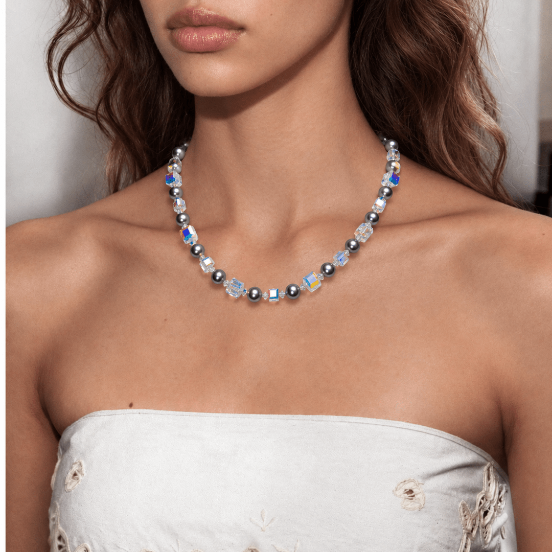 Midnight Prism Pearl Choker with dark gray pearls and iridescent crystal cubes, worn with a white embroidered strapless top.