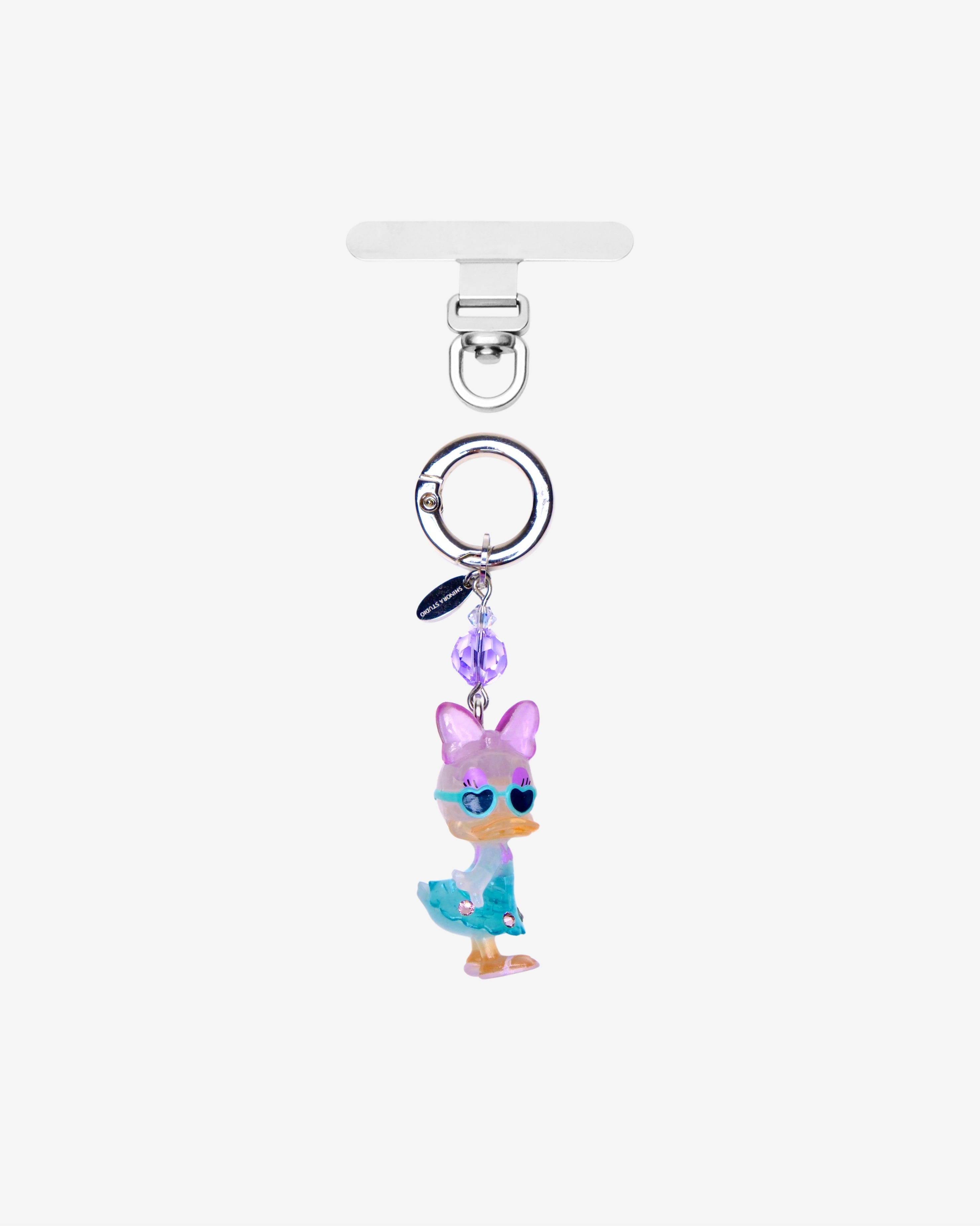 Lavender and blue duck phone charm with a purple crystal accent, silver ring and clear attachment tab.