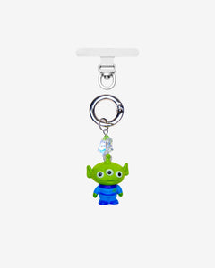 Green three-eyed alien phone charm with a green crystal star and silver-tone attachment hardware, shown on white.