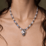 Midnight Bonnet Cat Charm Necklace with gray pearls and iridescent crystal cubes, shown worn around the neck.