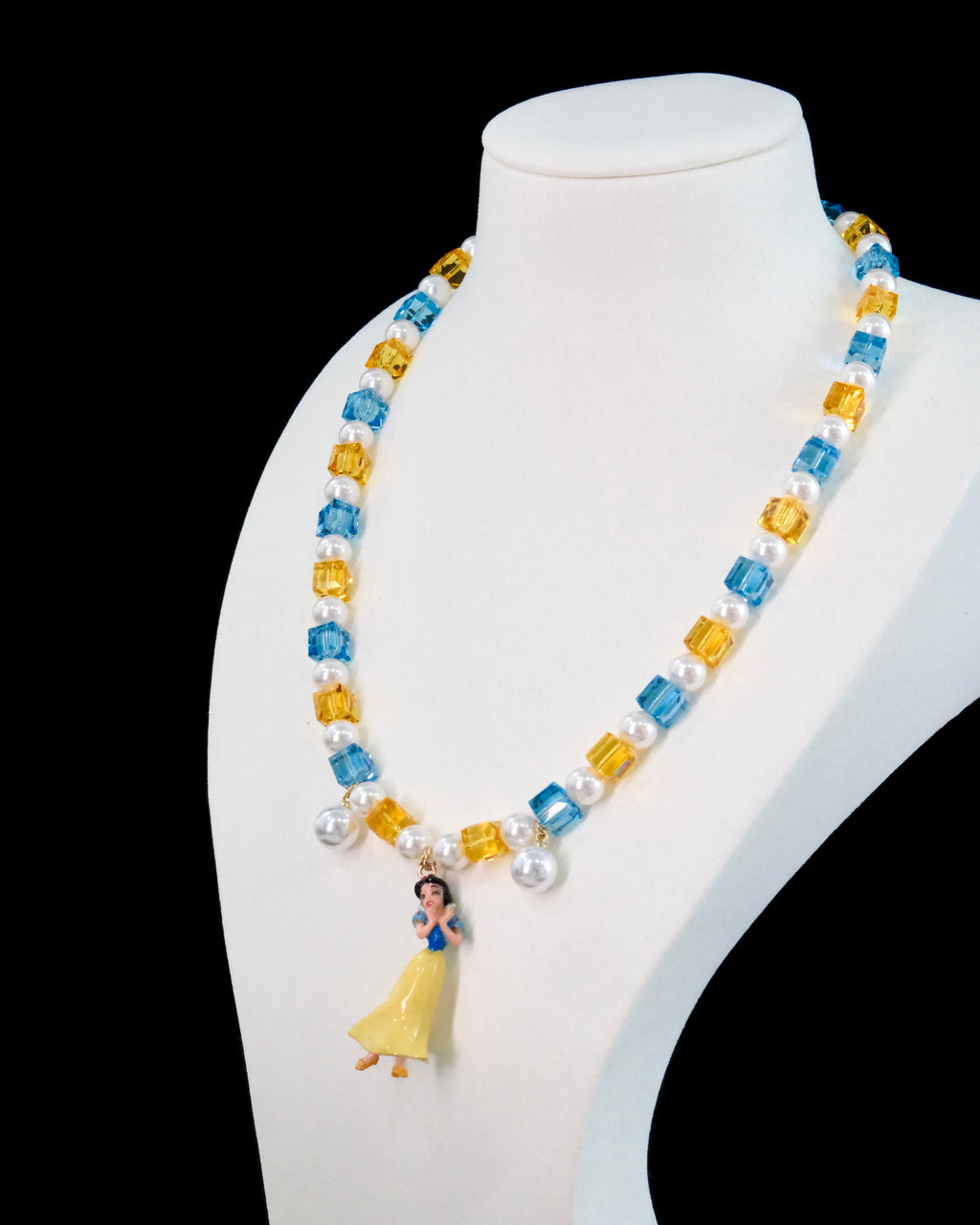 Model wearing handmade ruby and sapphire crystal charm necklace with Swarovski pearls