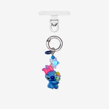 Detachable phone charm with a blue creature wearing a pink bow, a smaller colorful figure, blue crystals and a silver-tone ring.