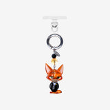 Orange fox character phone charm with a small crystal accent, silver ring and clear attachment tab.