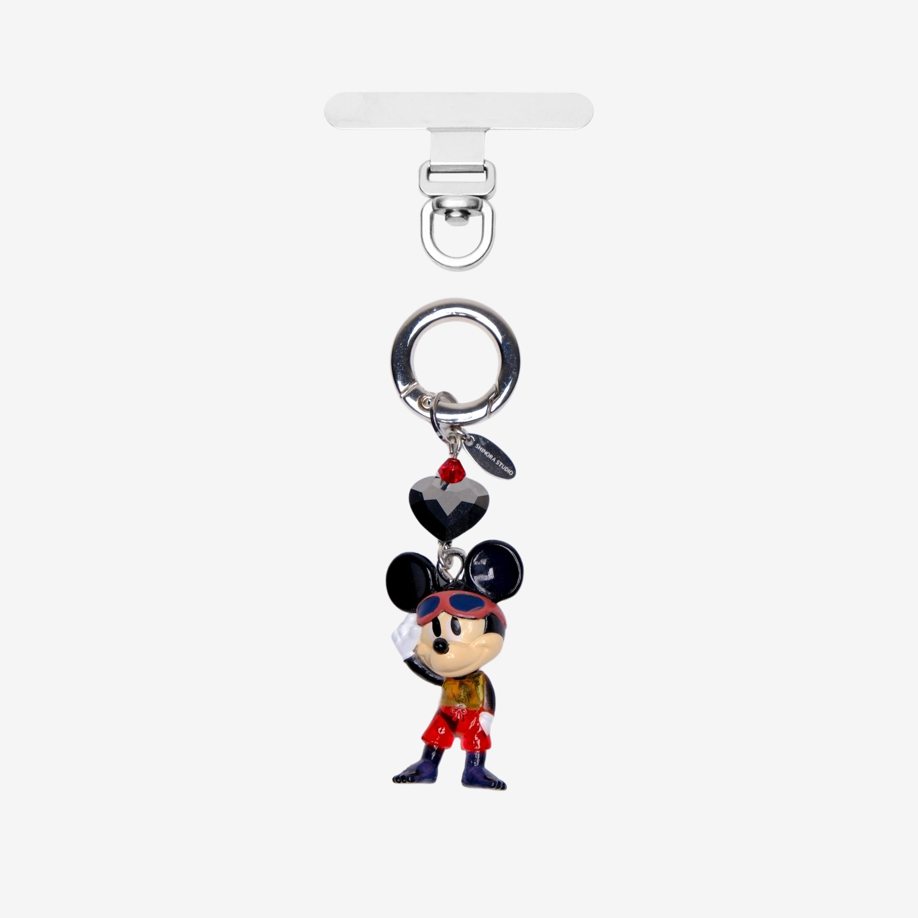 Black-eared mouse character phone charm in red trousers, with dark crystal accents and a silver attachment ring.