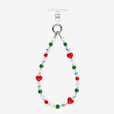 Red heart crystal phone chain with green and red cube beads, iridescent accents and silver-tone attachment rings.