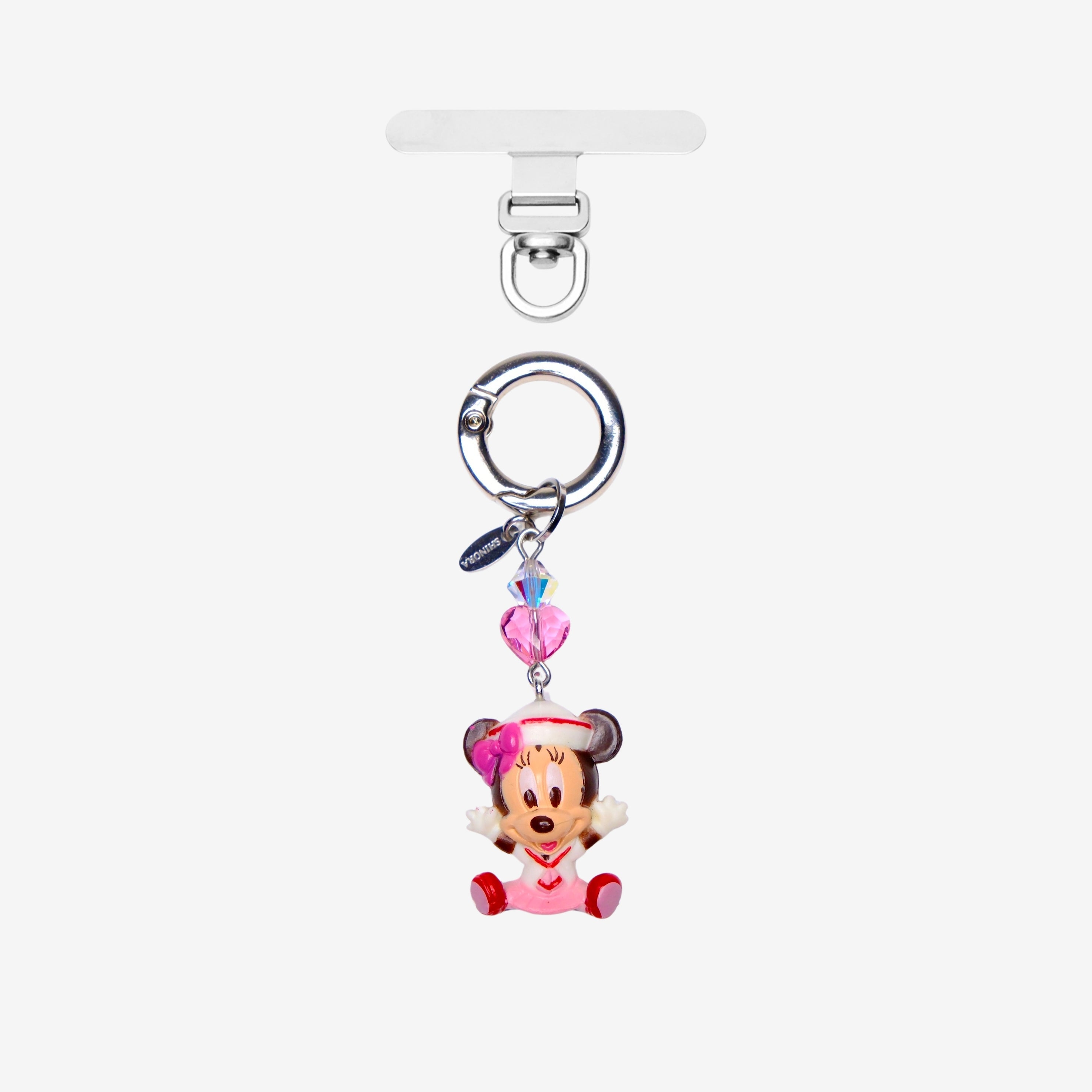 Mouse phone charm with a pink bow and pink crystal heart, shown with silver-tone attachment hardware on white.