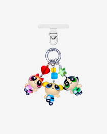 Three detachable phone charms with cartoon girl figures in pink, blue and green, colorful crystals and silver-tone rings.