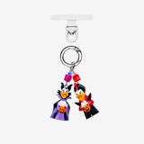 Detachable phone charm with two duck figures in Halloween costumes, pumpkin details, purple and red crystals and a silver-tone ring.