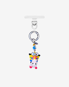 Detachable phone charm with a yellow goggled figure riding a white unicorn, colorful crystals and a silver-tone ring.
