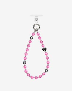 Pink crystal beaded phone chain with a black heart, dark geometric beads and silver-tone attachment rings.