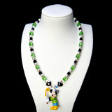Green crystal and white pearl necklace with black heart beads and a sporty mouse charm, displayed on a white bust.