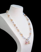 Model wearing handmade crystal charm necklace with Swarovski pearls - unique wedding jewelry
