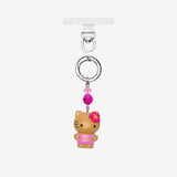 Flower-topped cat phone charm in a pink outfit, with pink crystal accents and silver-tone attachment hardware on white.