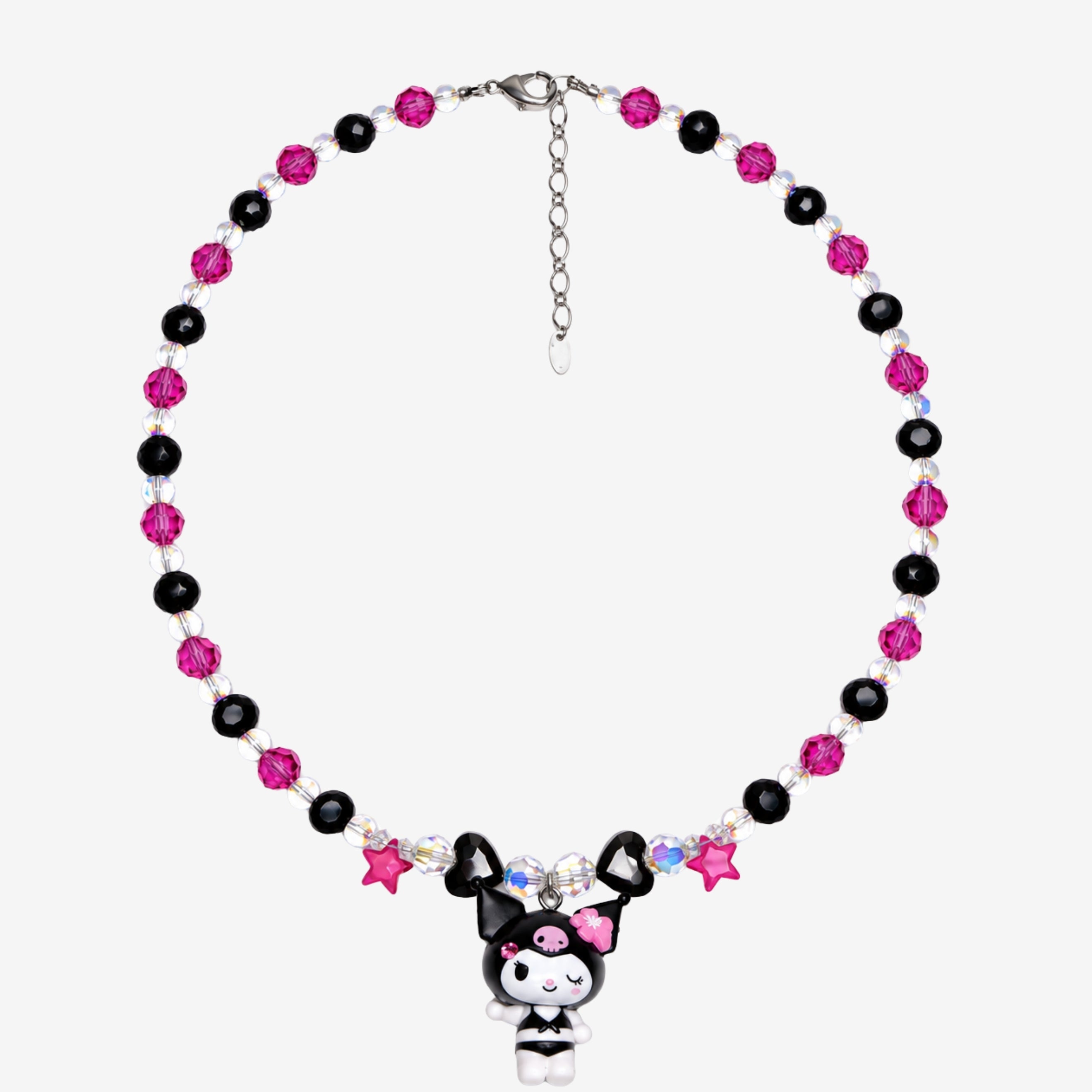 Pink and black crystal necklace with pink stars, black hearts, a winking character charm and silver extension chain laid flat.