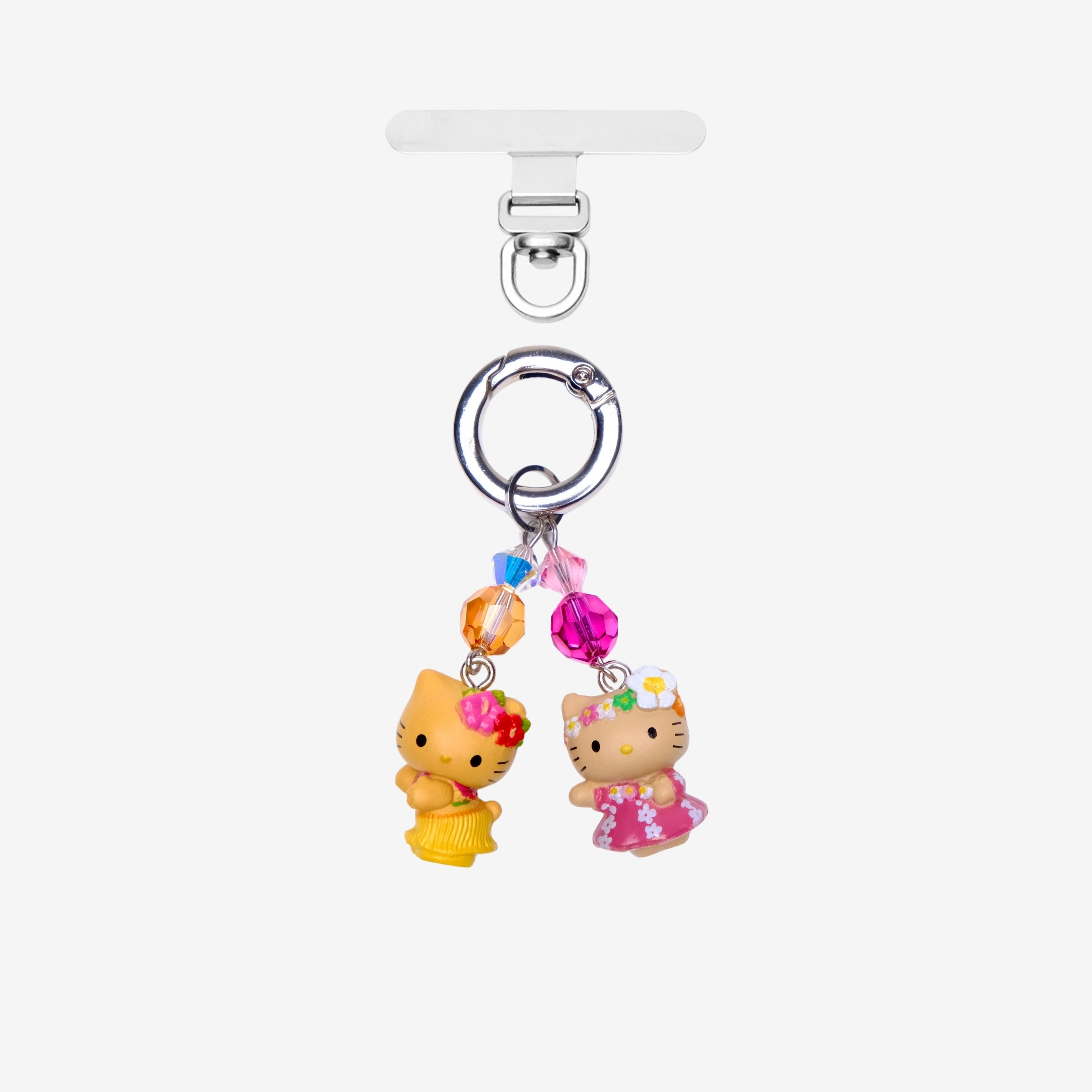 Two tropical cat phone charms in pink and yellow outfits with orange and pink crystals and silver-tone attachment hardware.
