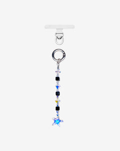 Straight phone chain with black cube crystals, clear faceted accents and a blue star crystal, shown below a silver-tone ring.