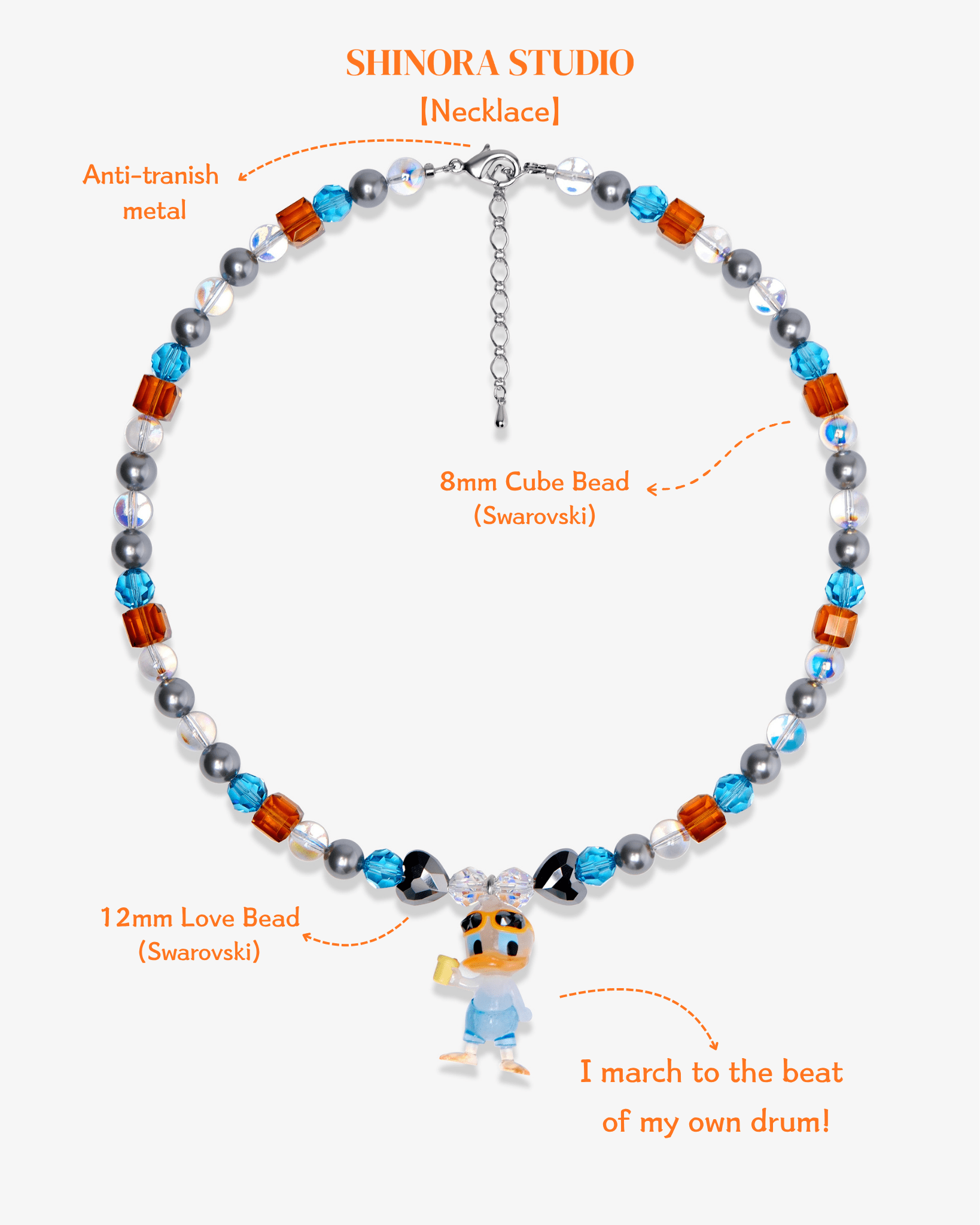 Close-up detail of Orange & Blue Duck Charm Necklace · handmade Swarovski crystal jewelry