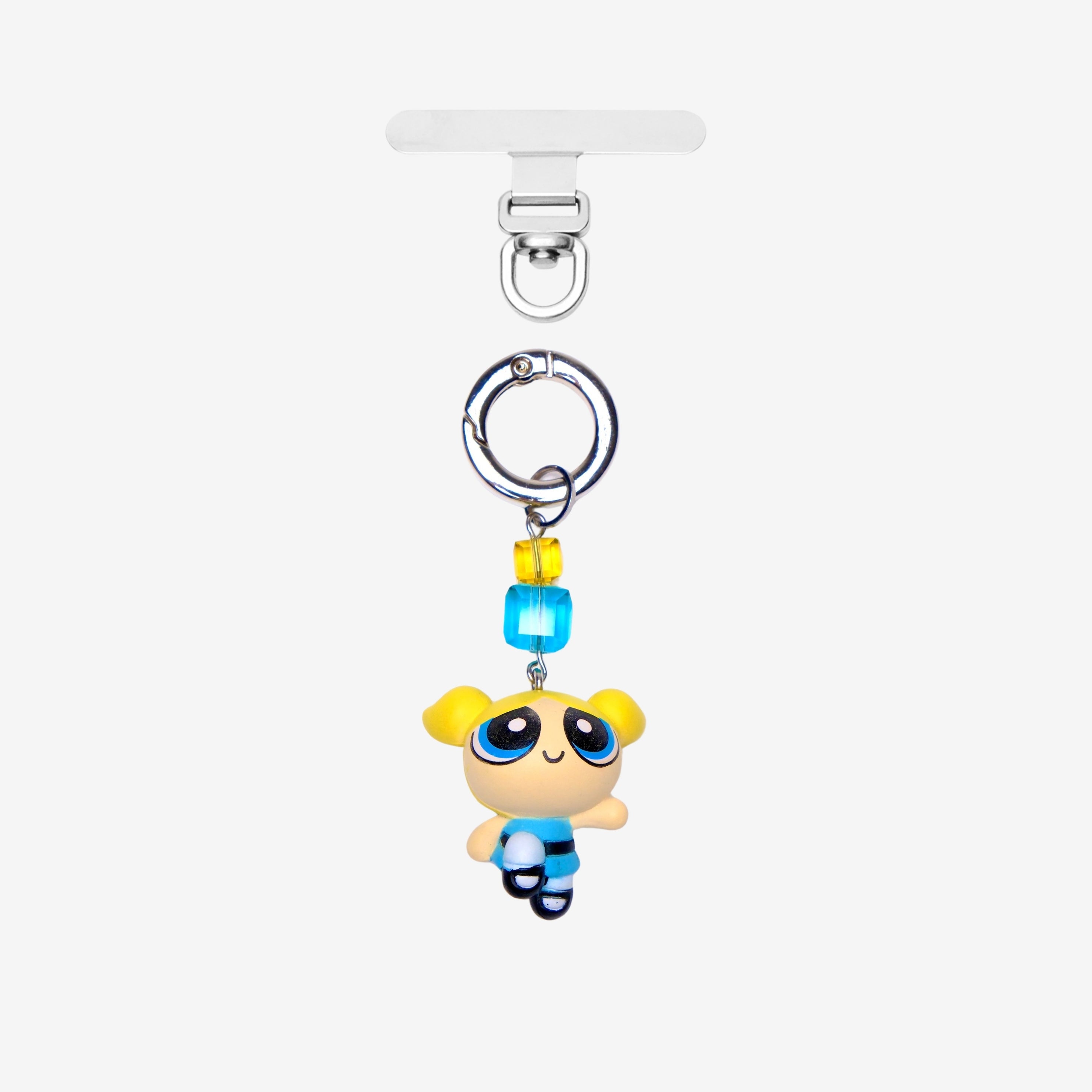 Detachable phone charm with a blue cartoon girl figure, yellow and turquoise crystals and a silver-tone ring.