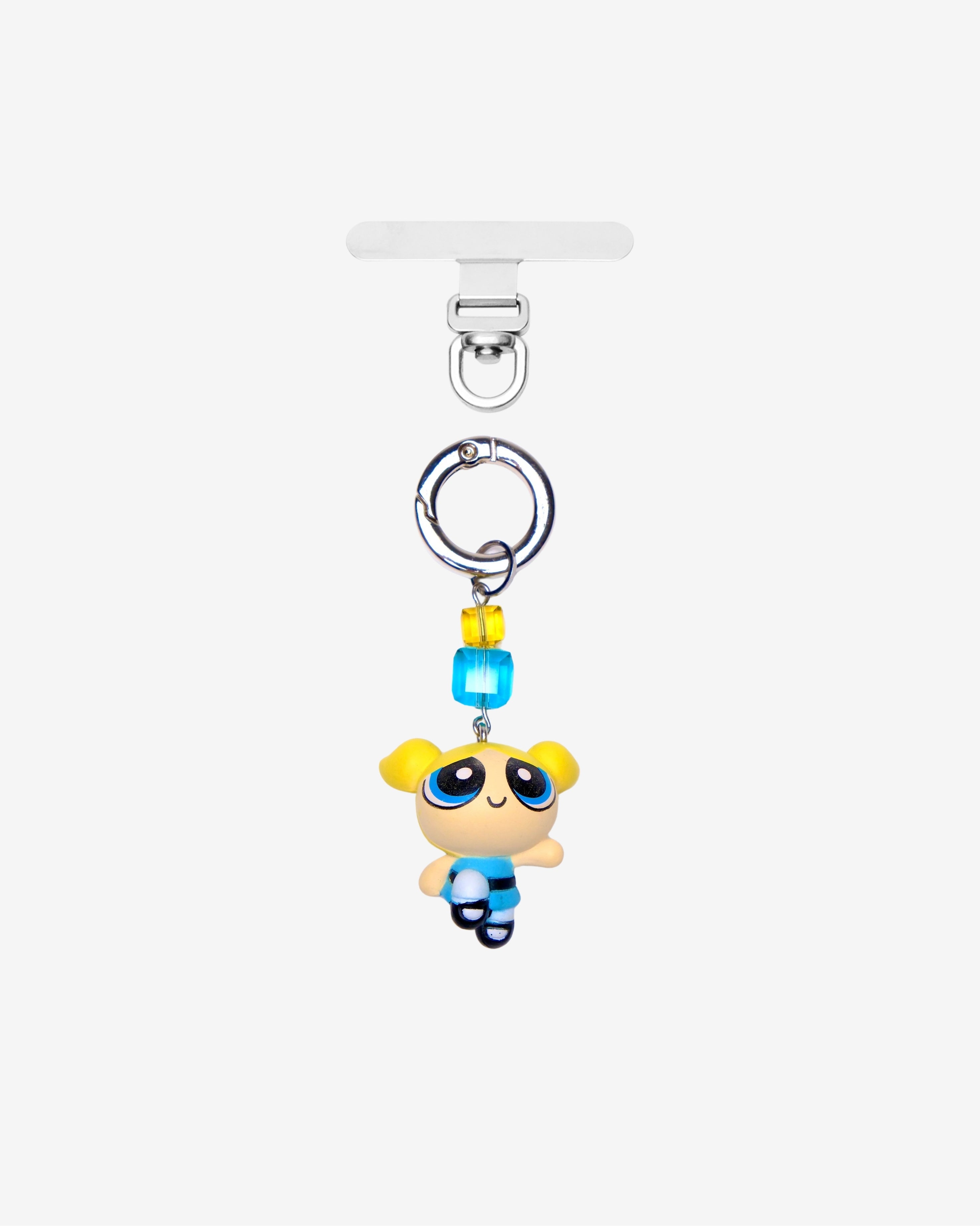 Detachable phone charm with a blue cartoon girl figure, yellow and turquoise crystals and a silver-tone ring.