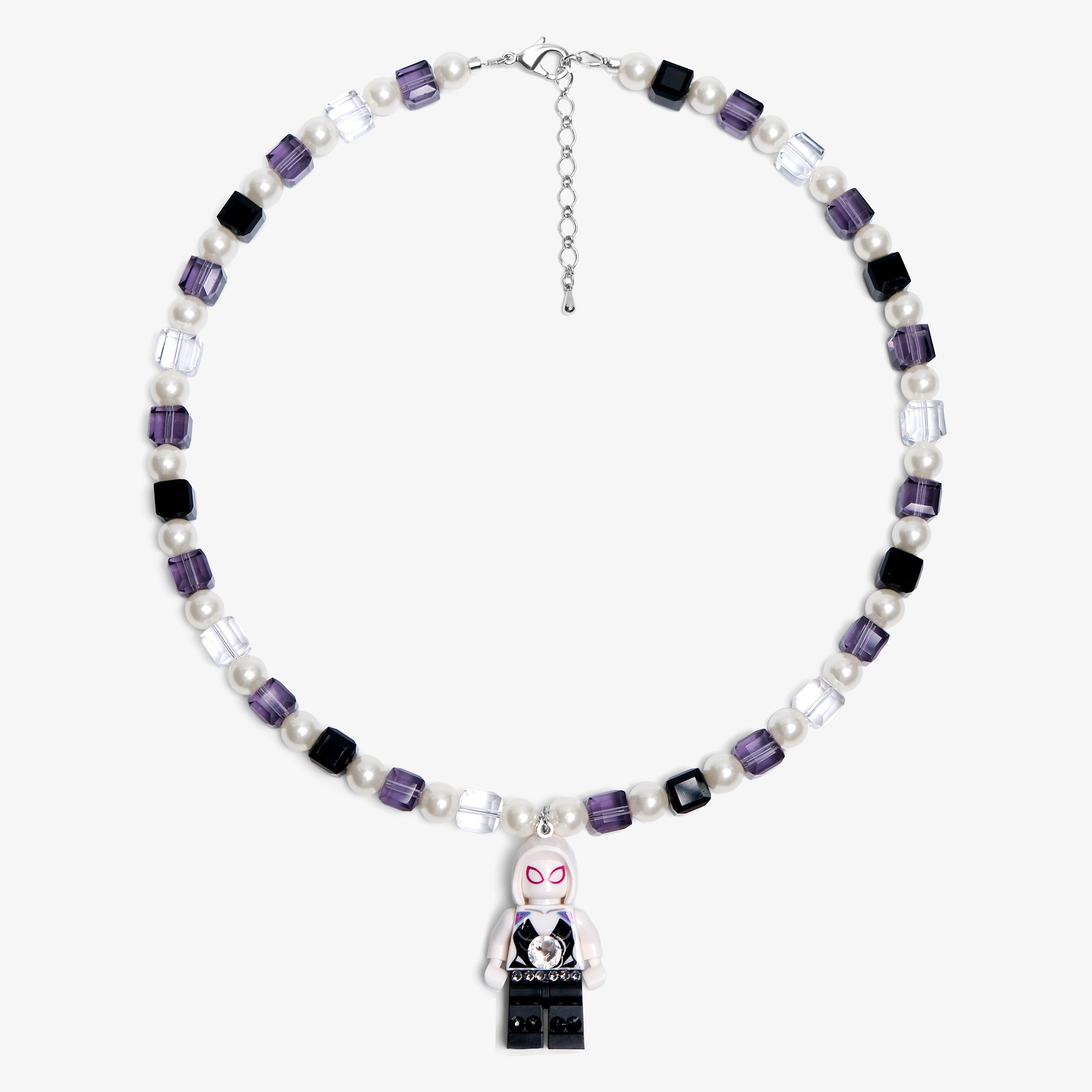 Studio product photo of a handmade pastel crystal charm necklace with white pearl accents and a playful vintage-inspired pendant.