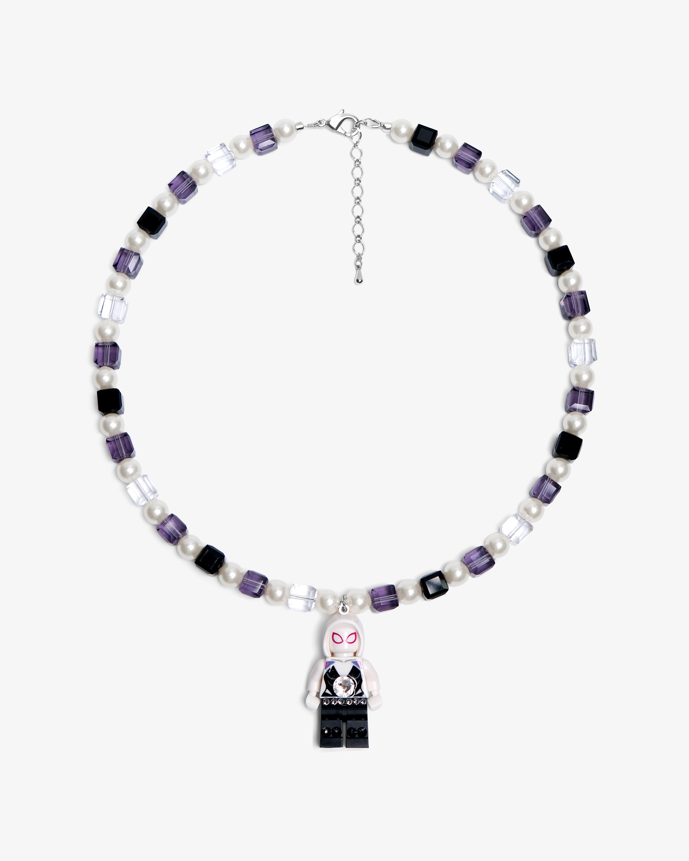 Studio product photo of a handmade pastel crystal charm necklace with white pearl accents and a playful vintage-inspired pendant.