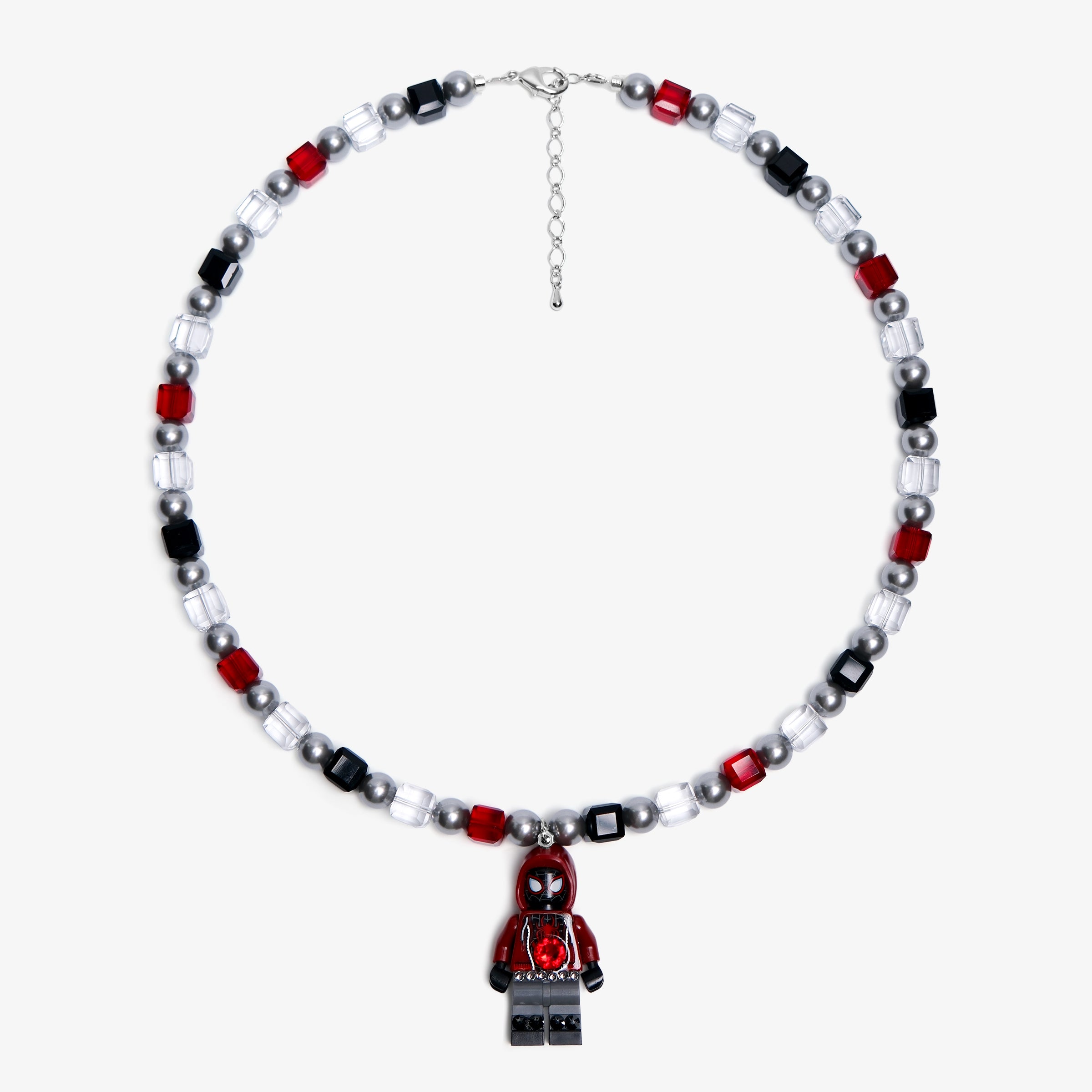 Studio product photo of a handmade red, black, and clear crystal charm necklace with pearl accents and a city-inspired collectible pendant.