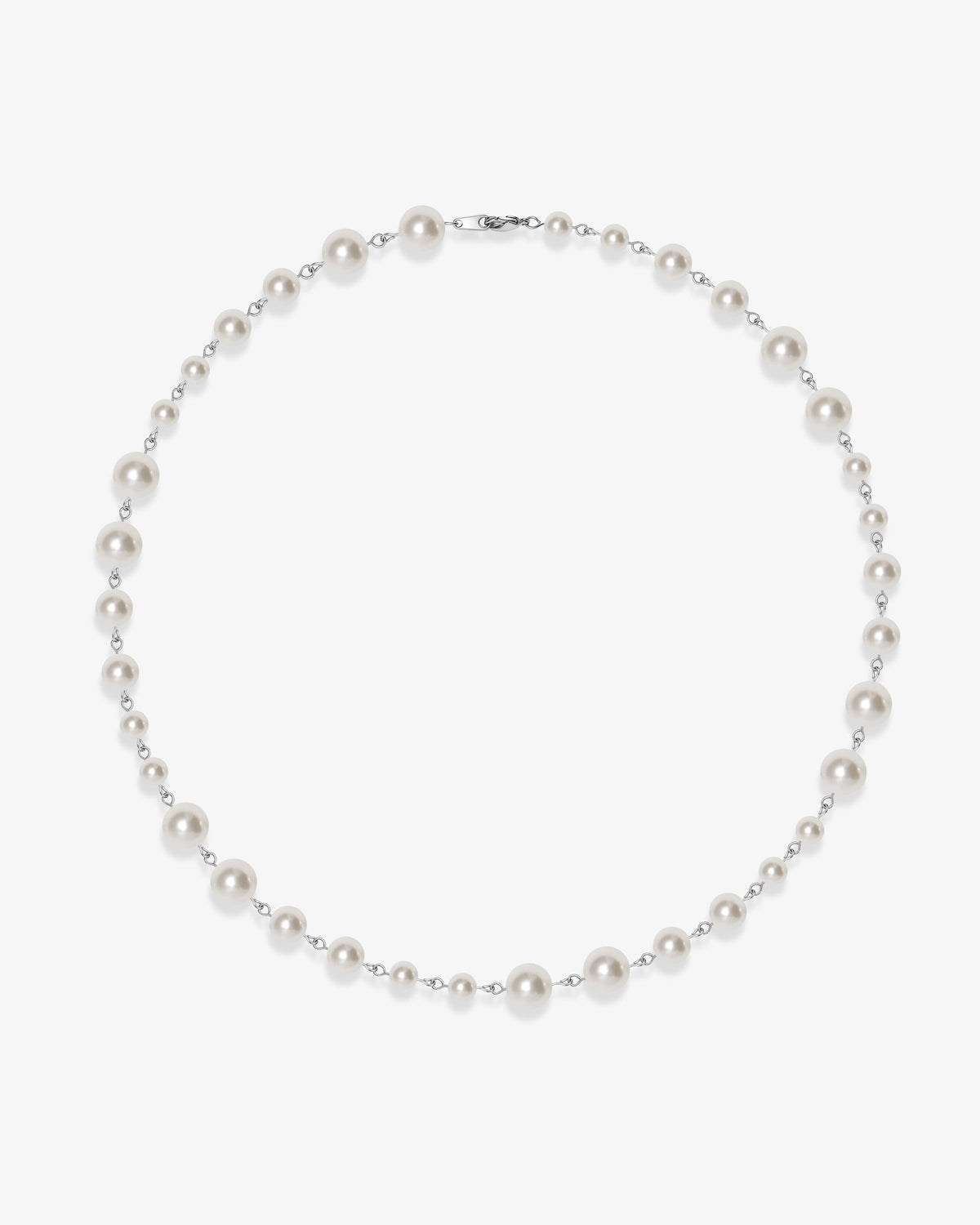 Handmade Swarovski pearl necklace petite length with white pearls and silver chain - flat lay