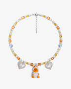 Handmade yellow and amber Swarovski crystal and pearl charm necklace with vintage pendant - flat lay