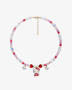 Handmade pink and ruby Swarovski crystal charm necklace with pearl hearts and vintage pendant - flat lay