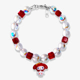 Studio product photo of a handmade red Swarovski crystal charm bracelet with pearls and vintage-inspired charm details.