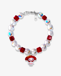 Studio product photo of a handmade red Swarovski crystal charm bracelet with pearls and vintage-inspired charm details.