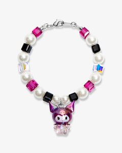 Studio product photo of a handmade purple Swarovski crystal charm bracelet with pearls and vintage-inspired charm details.