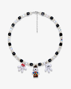 Studio product photo of a handmade colorful Swarovski crystal charm necklace with pearls and vintage-inspired charm details.