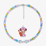 Close-up detail of a handmade rainbow Swarovski crystal charm necklace with pearls and vintage-inspired charm details.