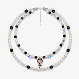 Double-layer handmade Swarovski crystal charm necklace with white pearls, black cube crystals, iridescent star crystals, and vintage starlet charm.