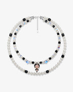 Double-layer handmade Swarovski crystal charm necklace with white pearls, black cube crystals, iridescent star crystals, and vintage starlet charm.