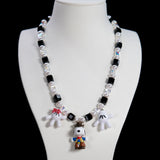 Product detail view of a handmade colorful Swarovski crystal charm necklace with pearls and vintage-inspired charm details.