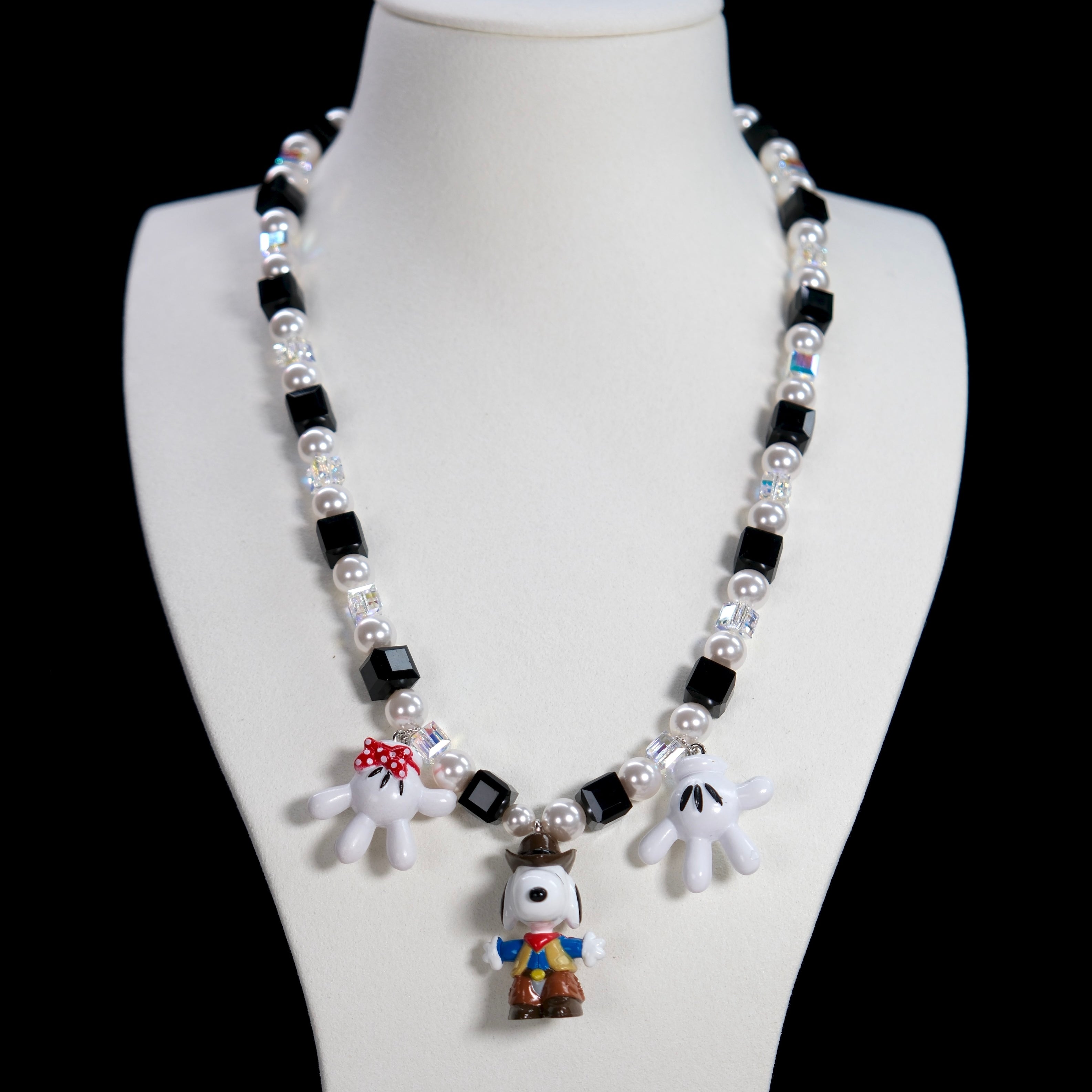 Product detail view of a handmade colorful Swarovski crystal charm necklace with pearls and vintage-inspired charm details.