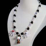 Product detail view of a handmade colorful Swarovski crystal charm necklace with pearls and vintage-inspired charm details.