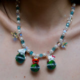 Close-up detail of a handmade colorful Swarovski crystal charm necklace with pearls and vintage-inspired charm details.