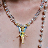 Close-up detail of a handmade blue Swarovski crystal charm necklace with pearls and vintage-inspired charm details.