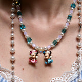 Detailed view of a handmade pastel Swarovski crystal charm necklace with pink and blue beads, pearl accents, and nostalgic collectible charms.
