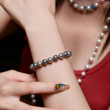 Model wearing a handmade charcoal gray Swarovski pearl bracelet in a monochrome jewelry look.