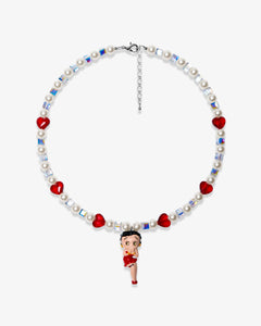 Studio product photo of a handmade red heart charm necklace with white Swarovski crystal pearls and iridescent cube beads.