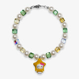 Studio product photo of a handmade yellow star charm bracelet with white Swarovski pearls and green, gold, and iridescent crystal beads.