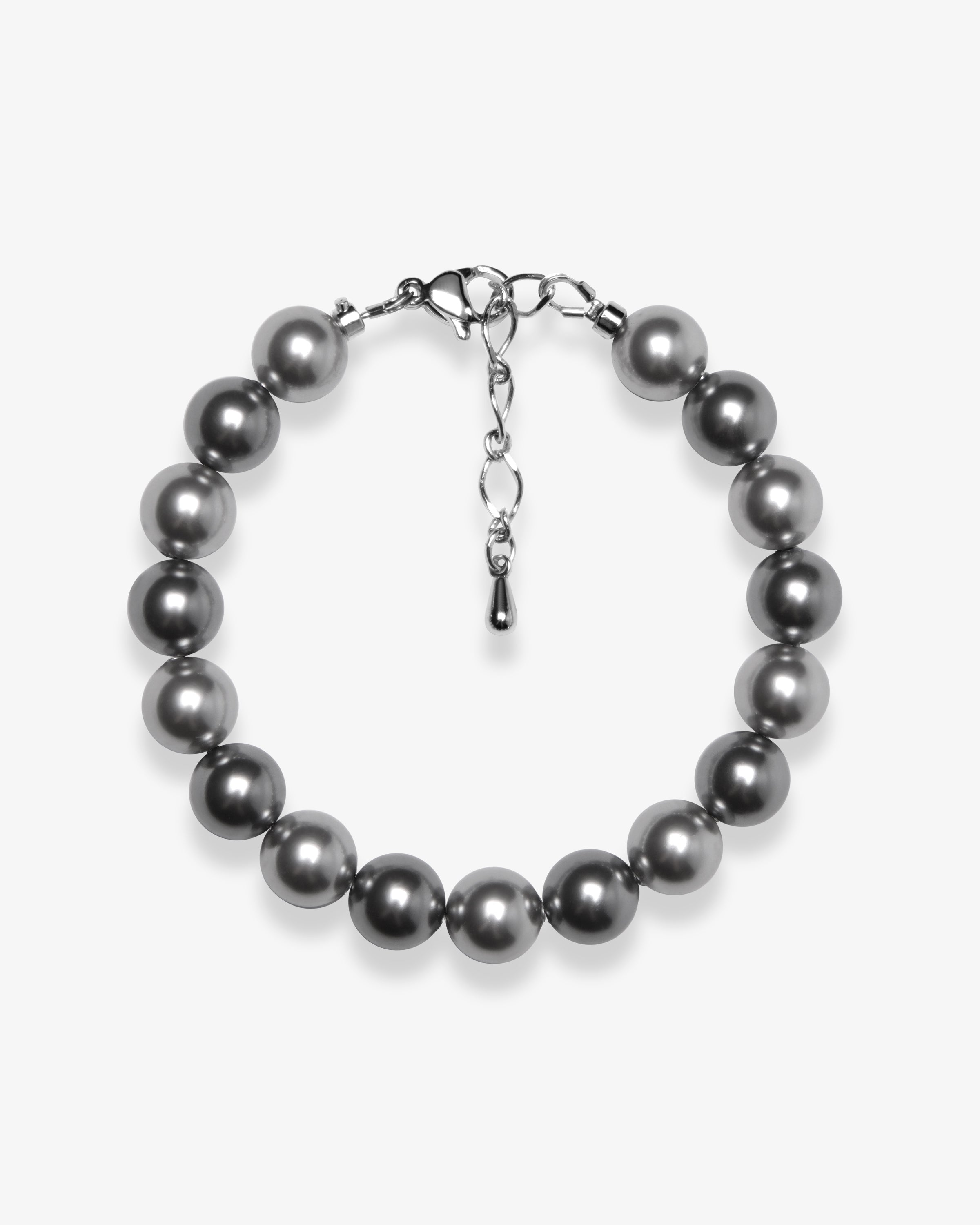 Studio product photo of a handmade charcoal gray Swarovski pearl bracelet with a silver clasp and adjustable extender chain.