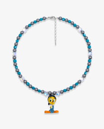 Studio product photo showing Blue and charcoal Swarovski crystal pearl charm necklace with a vintage yellow bird-inspired pendant.