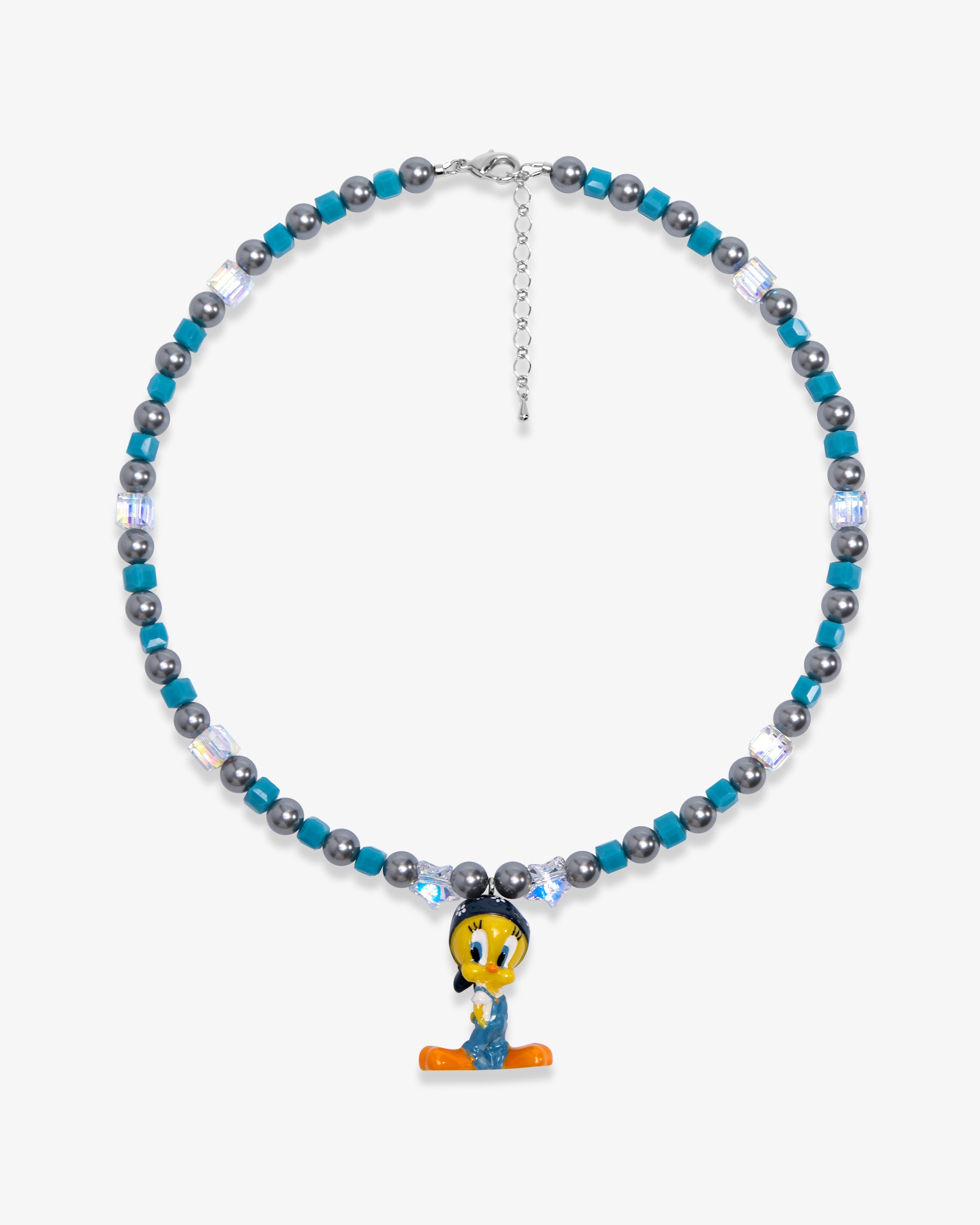 Studio product photo showing Blue and charcoal Swarovski crystal pearl charm necklace with a vintage yellow bird-inspired pendant.