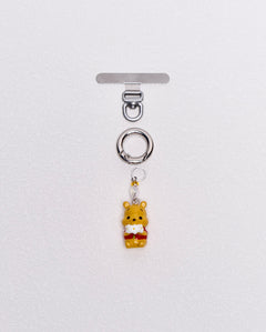 Product photo showing Vintage yellow bear-inspired phone charm with a crystal accent and silver-tone phone hardware.